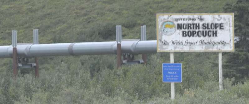 North Slope Borough boundary sign, in front of pipeline