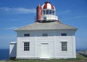 Old lighthouse at Cape Spear, with red and white roof over beacon