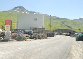 Entrance to Port Lekanoff, at end of Captains Bay Road on west side of Unalaska; private road beyond red No Trspassing sign