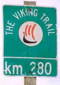 Old Viking Trail marker, faded green with Viking longboat, indicating 280 km distance