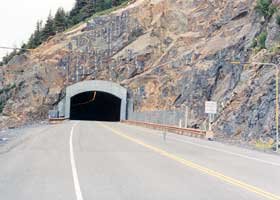 Two-lane highway tunnel under Begich Peak, east portal